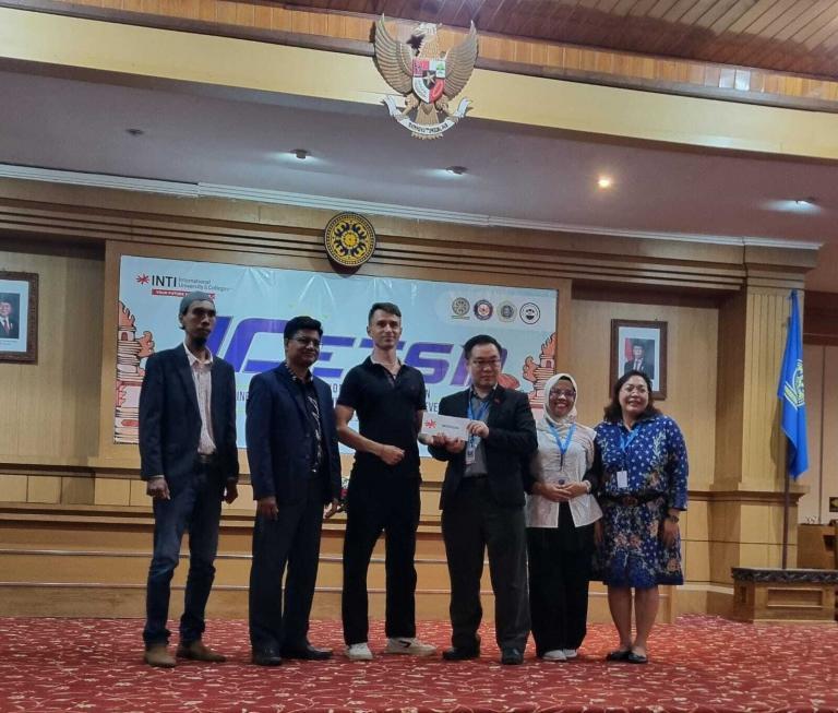 Radek Oborny receives awad fromd INTI and Udayana Staff.